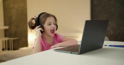 Girl Talking with Laptop in Bright Home Interior