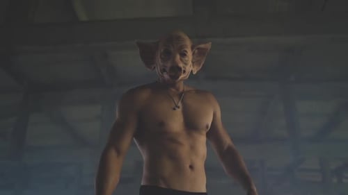 Bad Man with Terrifying Pig Mask Against Old Industrial Background