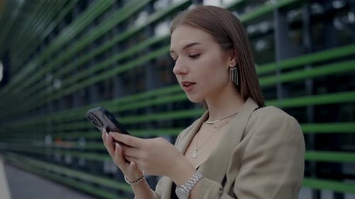 Woman Using Mobile Phone Outside in Urban Setting
