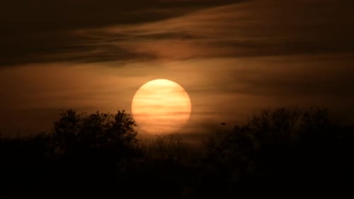 Sun Hiding between Clouds at Sunset