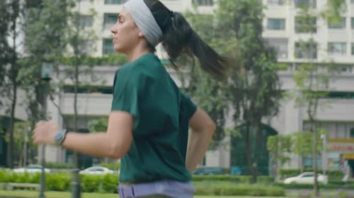 Woman Running in an Urban Park for Fitness