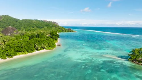 Coastal View of a Small Island Surrounded By Clear Water La Digue Seychelles