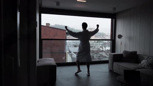 Man in Robe Dancing in Apartment