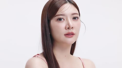 Slow motion shot Close up face of young beautiful young Asian woman with healthy and fresh skin.