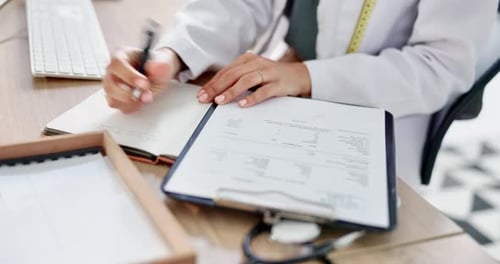 Healthcare, office and doctor writing notes while doing medical research in a medicare clinic
