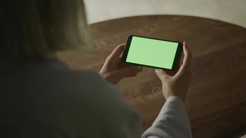 Woman Holding Smartphone with Green Screen