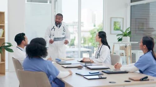 Black man, doctor meeting and xray for surgery planning, discussion and assessment in clinic