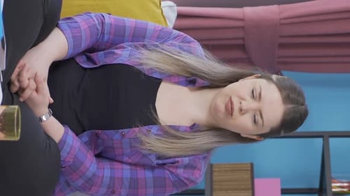 Woman Listening Attentively Indoors, Wearing Purple Plaid Shirt