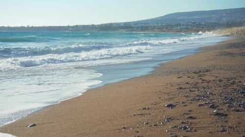 Wide Shot Blue Waves of Mediterranean Sea Rolling with Foam on Sandy Beach in Slow Motion Paradise