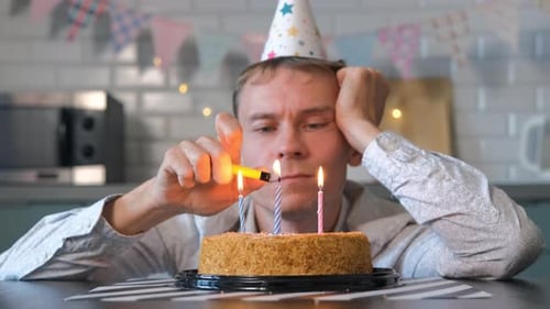 Lonely Man Lighting Birthday Candles on Cake