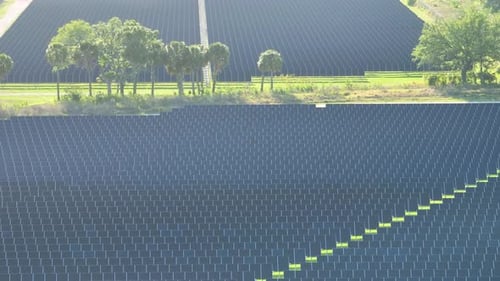 Aerial View of Big Sustainable Electric Power Plant with Many Rows of Solar Photovoltaic Panels for
