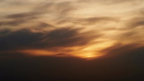 Golden Sky with Dark Clouds at Sunset