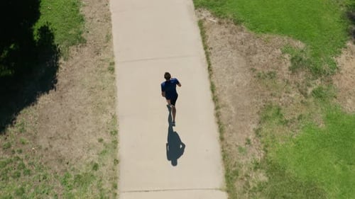 Overhead Aerial of Man Jogging in the Park