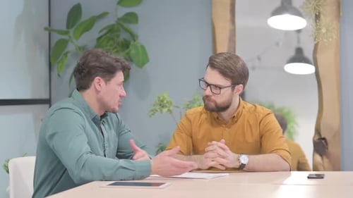 Men Discussing Business at Modern Workplace Table