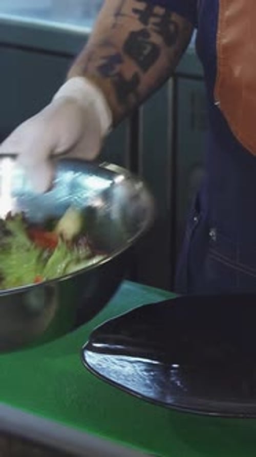 Chef Plates Fresh Salad in Restaurant Kitchen