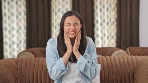 Indian woman suffering from tooth pain