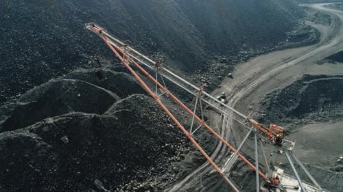 An Aerial View of Heavy Mining Equipment Engaged in Coal Excavation Within a Beautiful Landscape