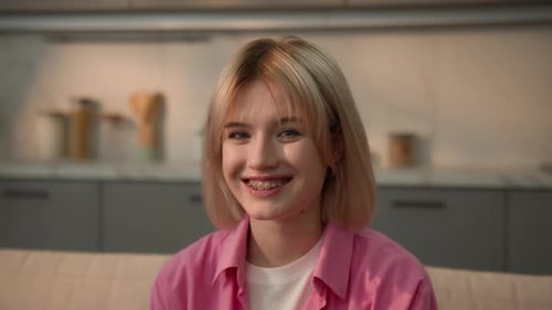 Teenage Girl Smiling at Home Wearing Braces