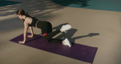 Woman Doing Donkey Kicks With Resistance Band