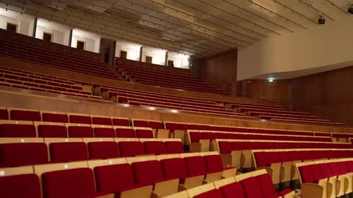 big empty concert hall with red seats in italy before the concert starts
