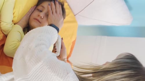 Loving Mother Taking Care of Sick Child