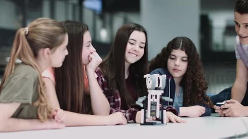Five Children working with small robot at school