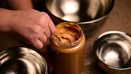 Scooping Peanut Butter With Metal Spoon