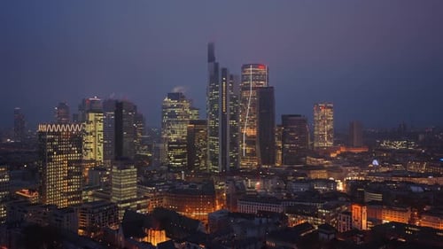 Panoramic View of Frankfurt's Skyline at Twilight Showcasing Illuminated Skyscrapers of Famous
