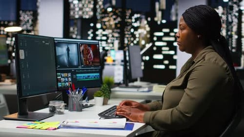 Woman Working at Computer in Modern City Office