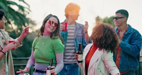 Young Adults Celebrating at Sunset on Rooftop