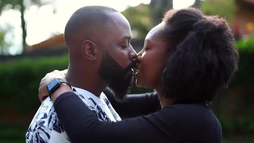 Loving Couple Shares Intimate Kiss in Garden