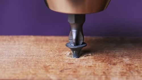 Screw Being Driven Into Wood Surface With Drill