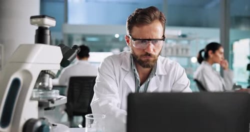 Scientist Using Microscope in Modern Bright Lab