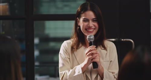 Young Woman Speaking at a Corporate Presentation