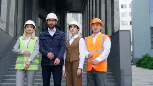 Construction Workers With Arms Crossed Stand Together