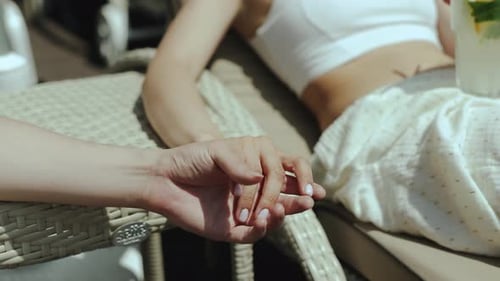 Couple Holding Hands on Tropical Vacation