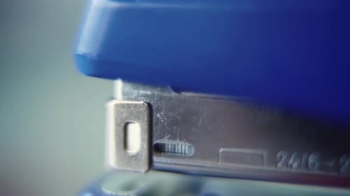 close up shot, pressing on a blue stapler, super slow motion 120 fps, Full HD