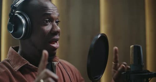 Male Vocalist Recording Music in Sound Studio