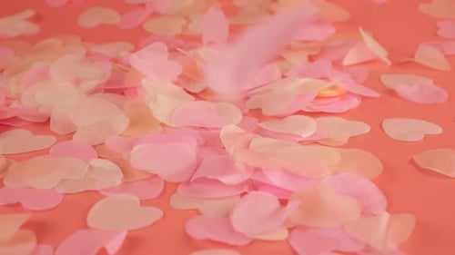 Pink Heart Confetti Falling onto Pink Background