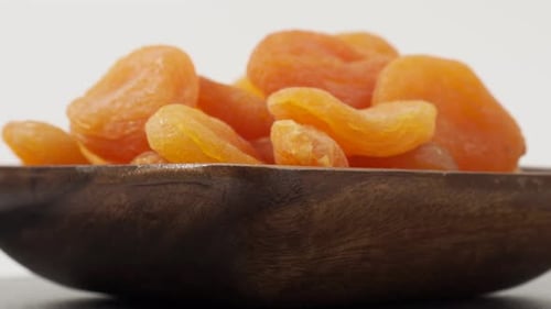 Dried Apricots in Wooden Bowl, Close Up