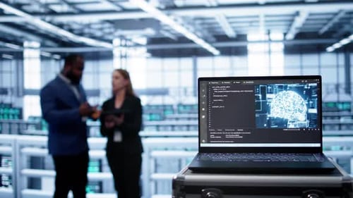 Focus on Laptop in Data Center with AI Brain Used By Engineers in Background