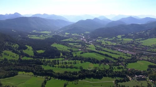 aerial flight over green forest on a mountain side, 4k