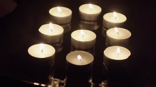 Burning Tea Light Candles in the Dark