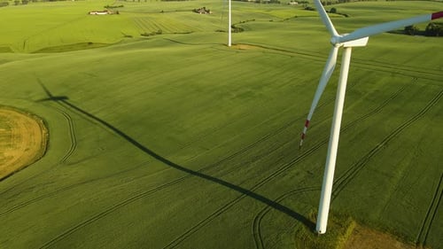 Electrical Energy From Wind Through Generator Farm Windmill with Rotating Blades in Countryside View