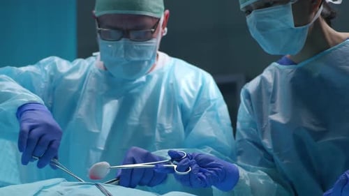 Team of Professional Medical Surgeons Performs the Surgical Operation in a Modern Hospital Doctors