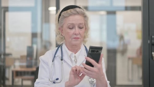 Mature Woman Doctor Using Mobile Phone