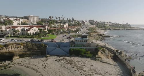 a beach with buildings and a body of water