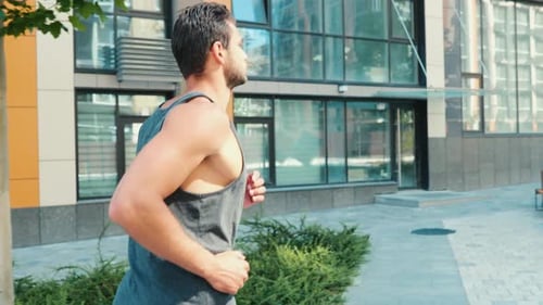 Young Man Exercising Outside Slow Motion of Guy's Legs Starting Jogging or Slow Running on Street