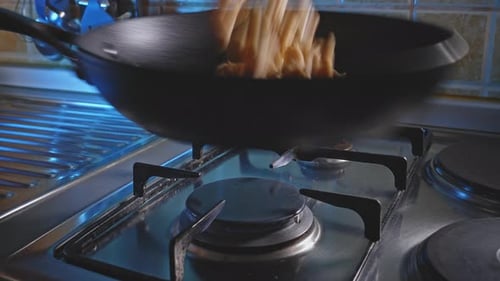 Pieces of Food Stir Fried on Gas Stove
