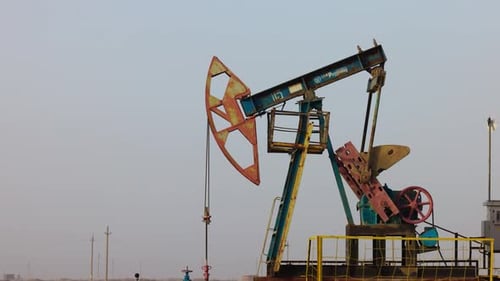 Oil Industry Pumping Petroleum Rig in Desert Pump Jack Extracting Crude Oil From a Oil Well Fossil